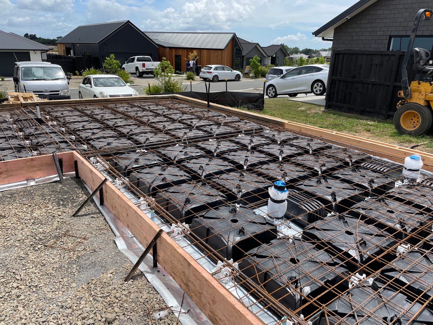 A floor slab ready for pour: polystyrene pods, steel reinforcing mesh and boxed edges.