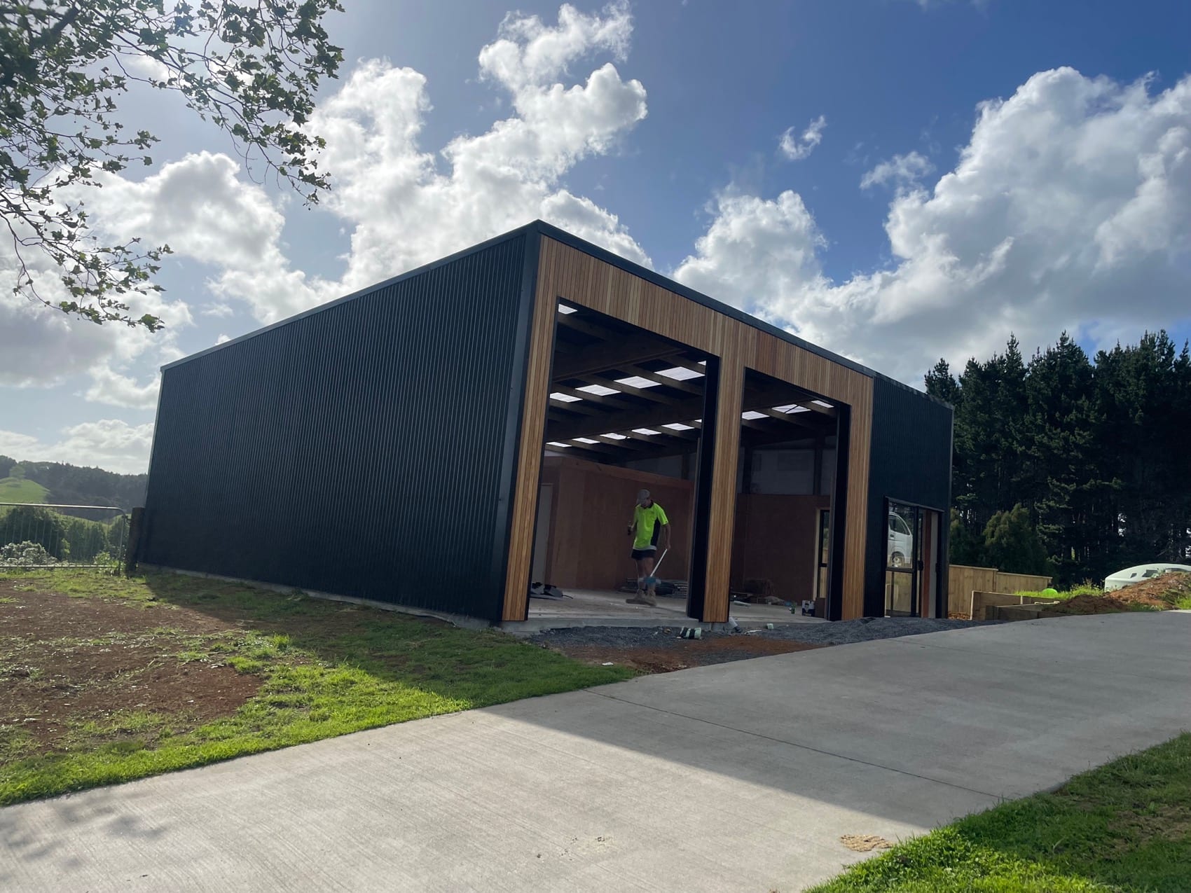 An open bay of the outbuilding with the concrete floor down and joinery in place.