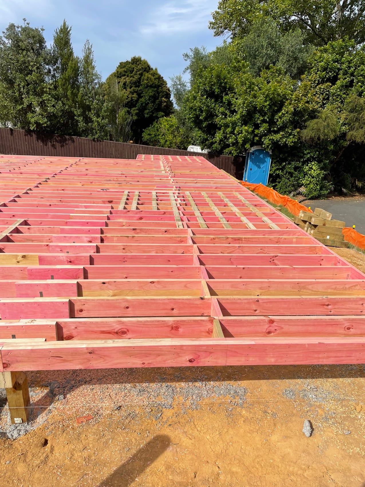 Treated floor joists set out across a new sub-floor.