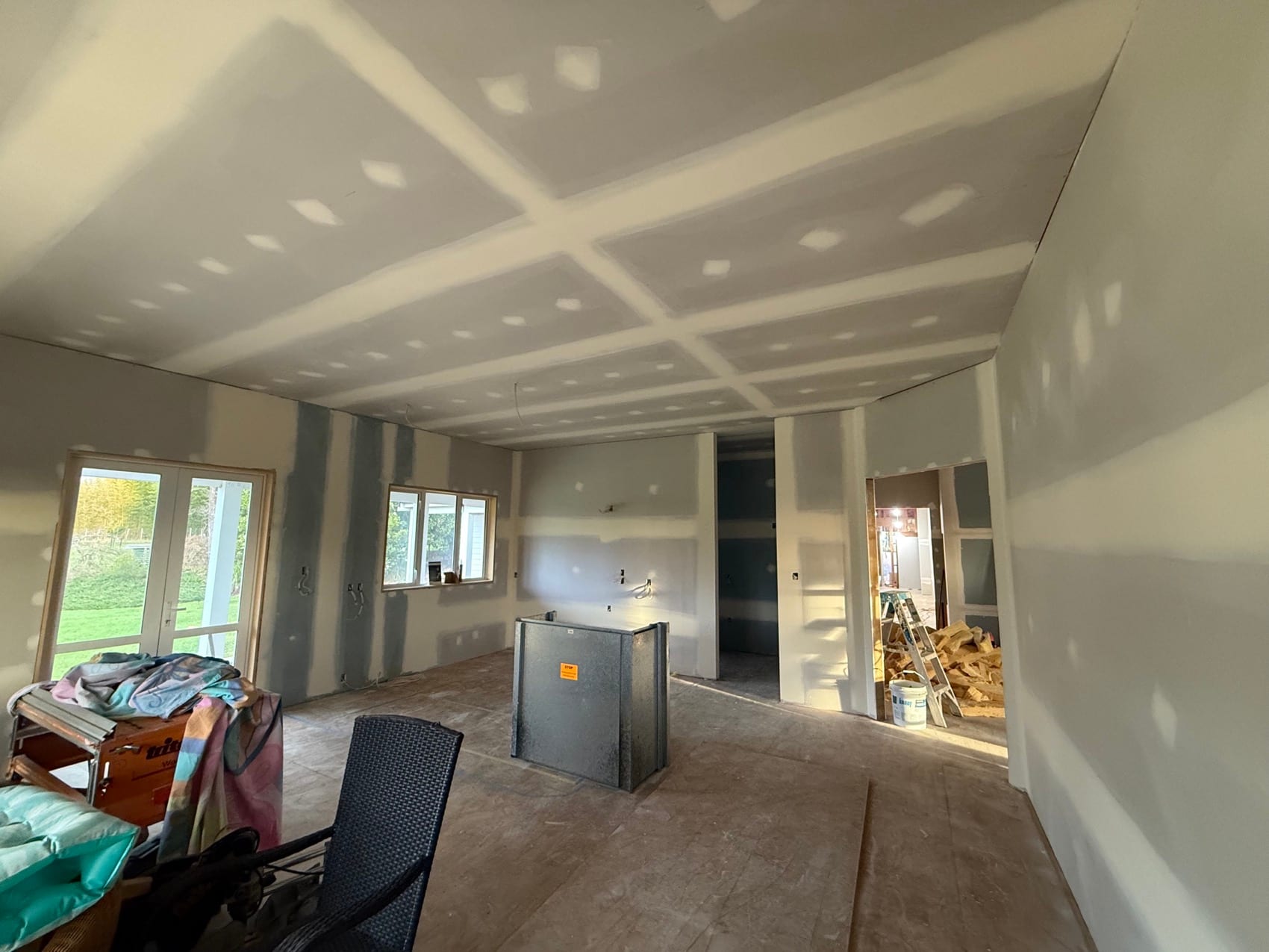 An interior at stopping stage, linings up and joins filled, with light coming through new joinery.