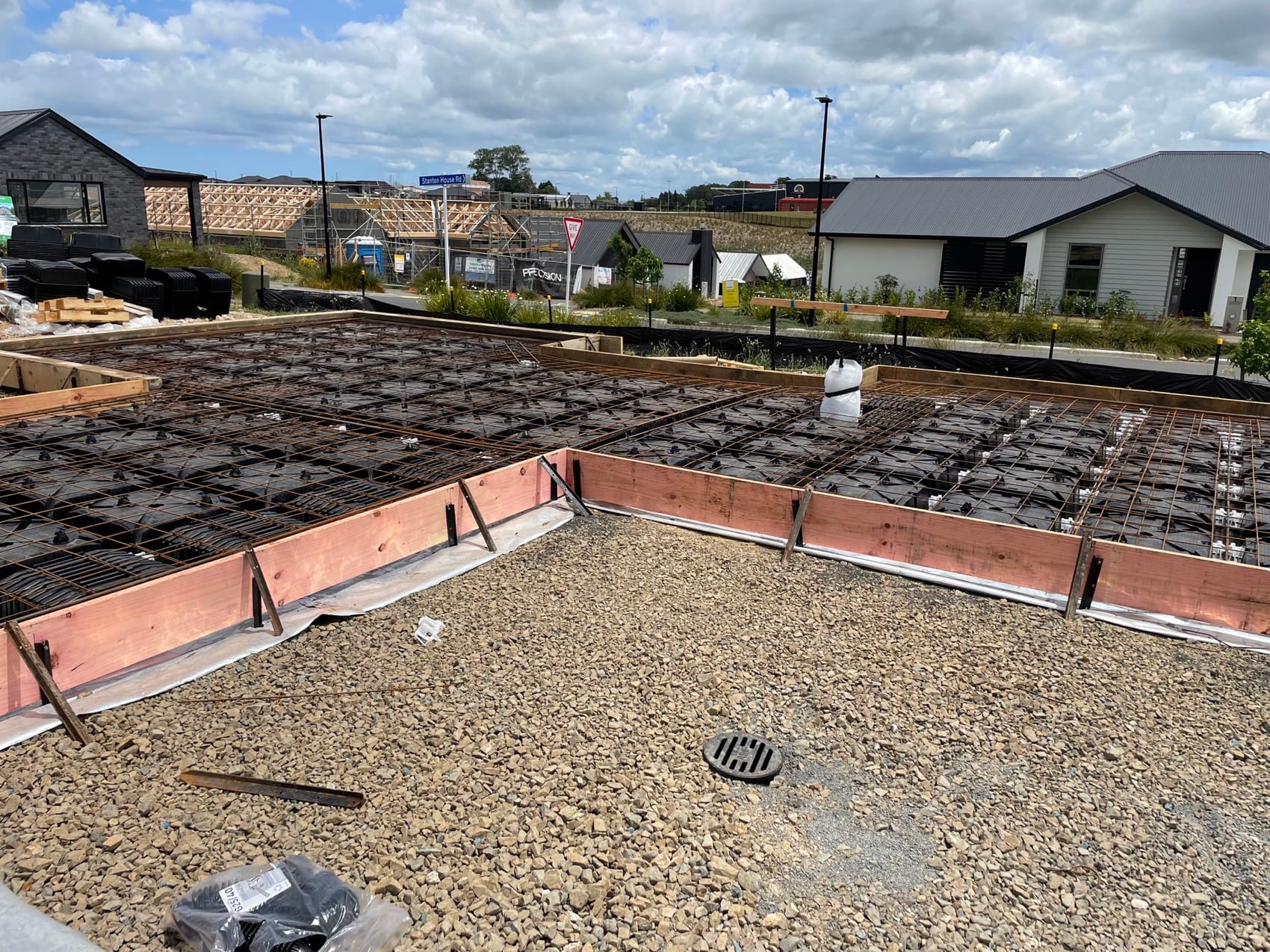 A boxed and reinforced floor slab ready for pour, with polystyrene pods and steel mesh in place.