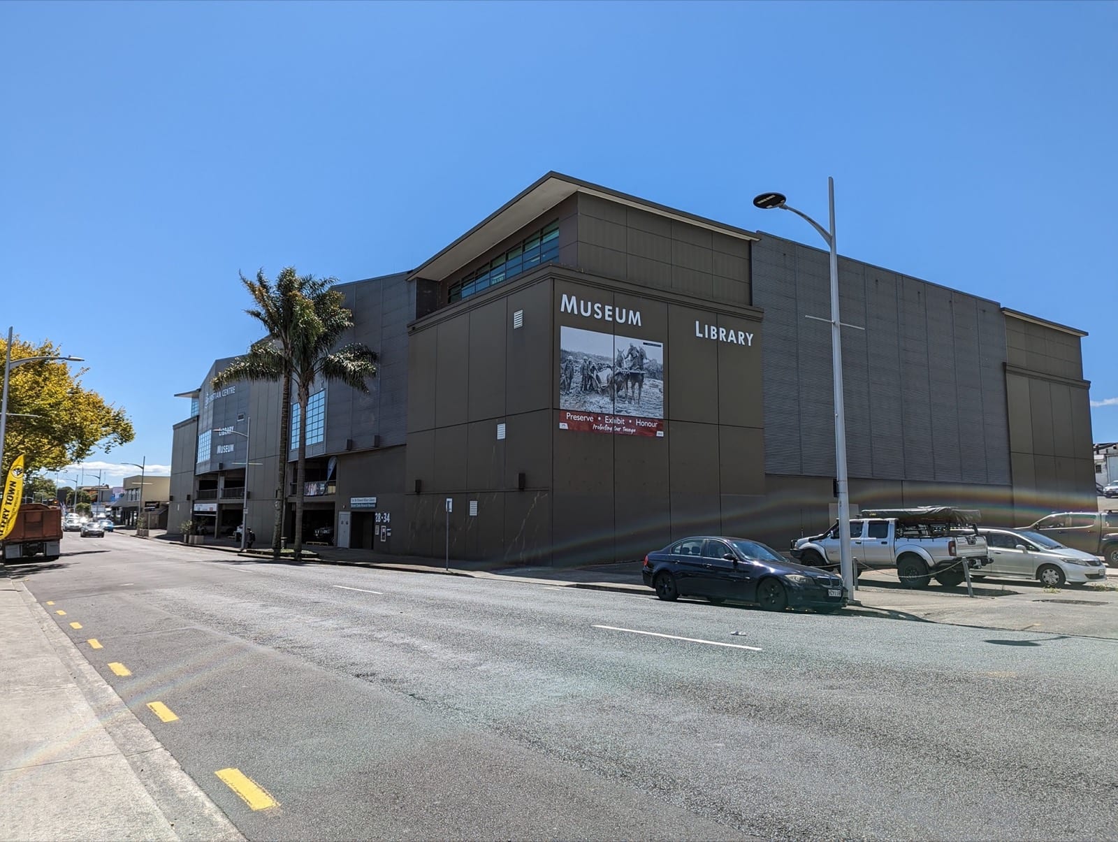 Papakura Museum and Library building on East Street, central Papakura, under a blue sky.
