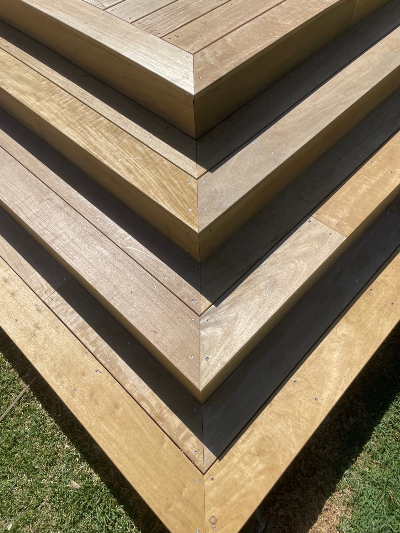 A close view of a mitred deck corner, boards meeting cleanly on the diagonal.