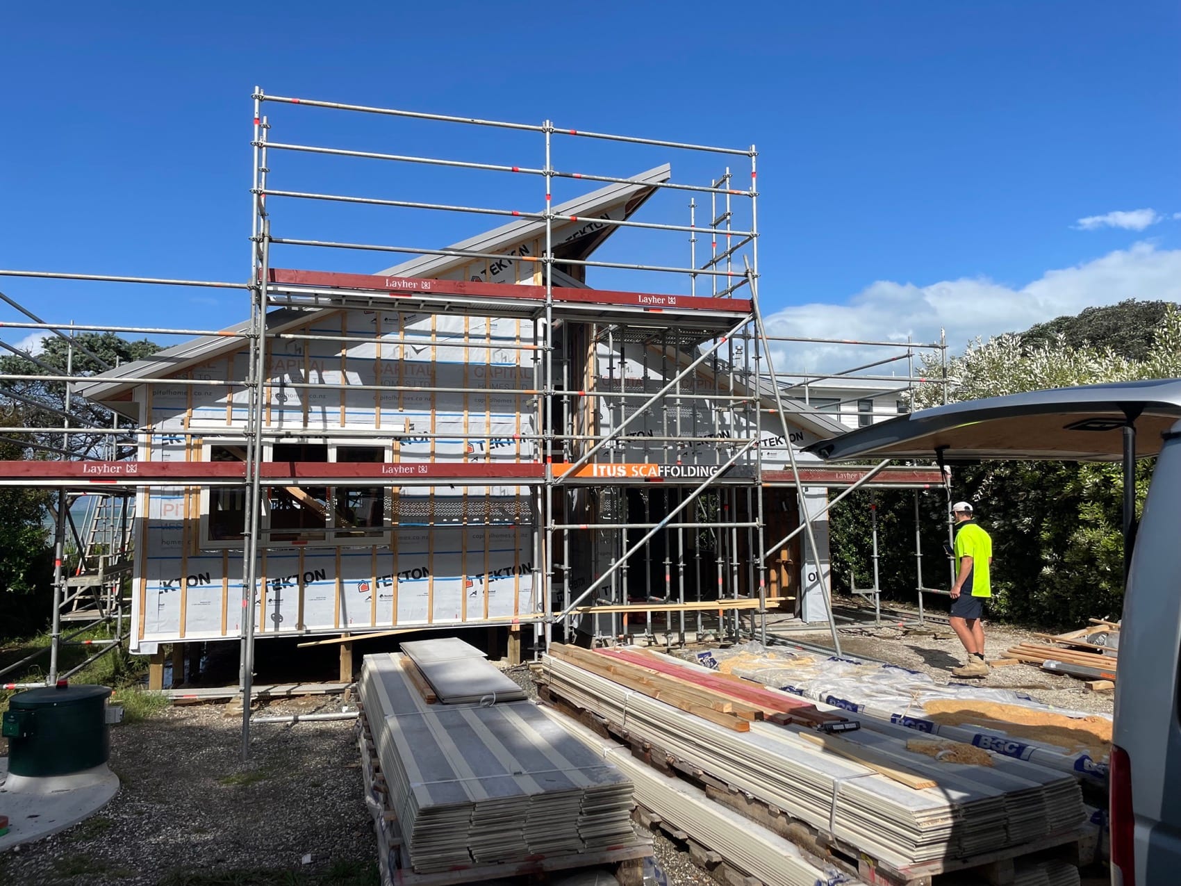 A two-storey build under scaffold with materials stacked ready to go up.